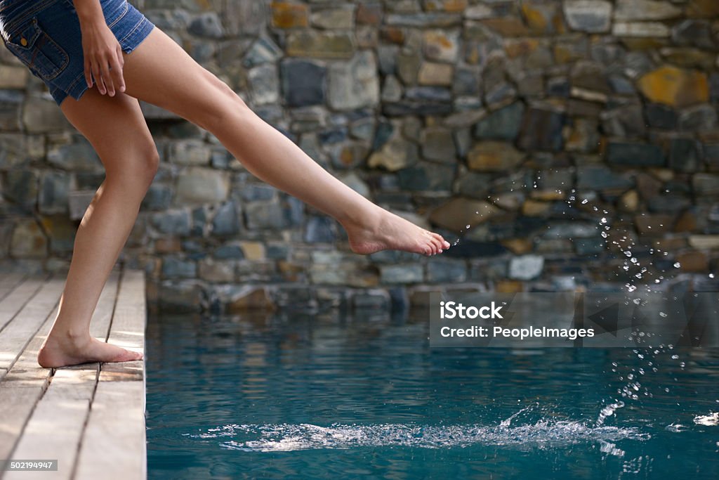 Just splashing around Cropped shot of a young woman testing the water of a swimming poolhttp://195.154.178.81/DATA/i_collage/pi/shoots/783592.jpg Adult Stock Photo