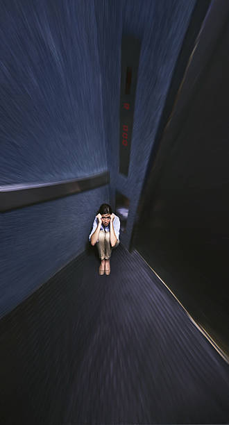 Trapped by her phobia Distorted shot of a young woman trapped in an elevatorhttp://195.154.178.81/DATA/i_collage/pi/shoots/783578.jpg ugly people crying stock pictures, royalty-free photos & images