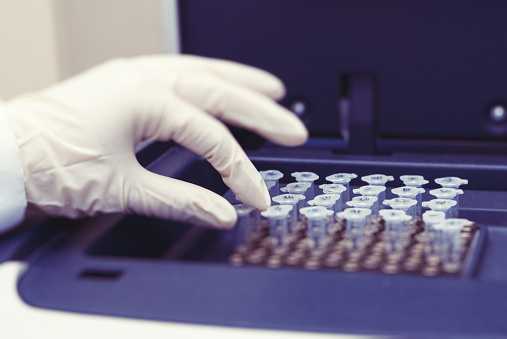 Technician using a centrifuge to separate the constituents of human semen