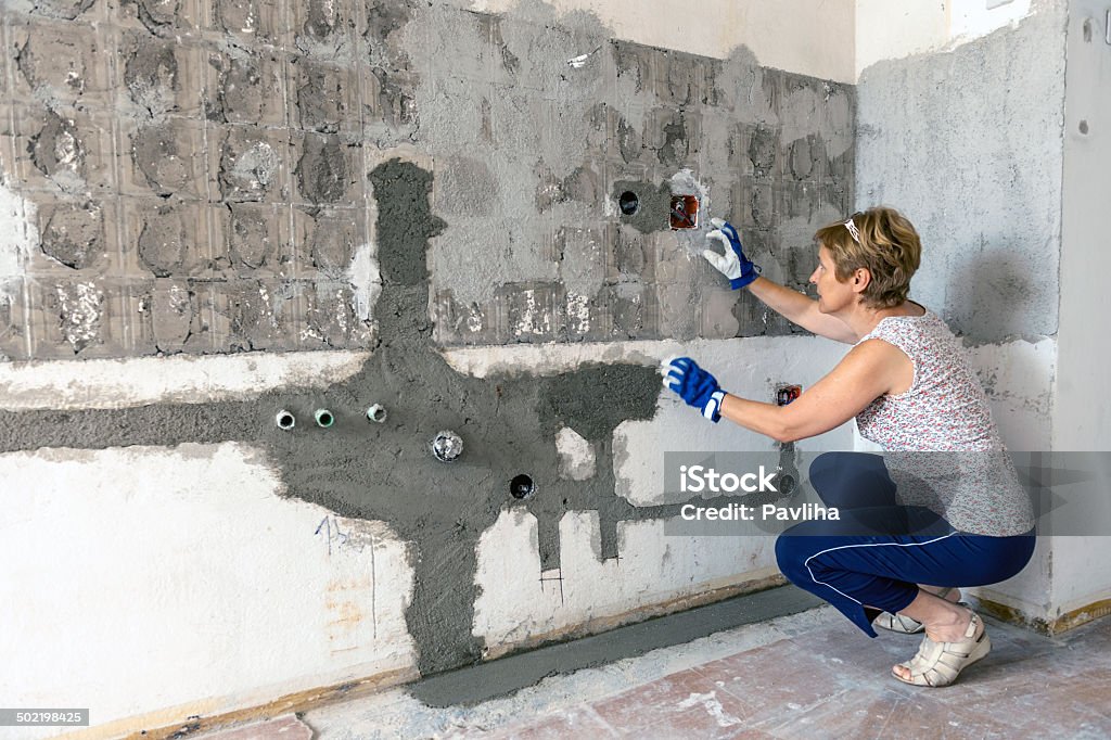 Home Addition - Office Renovation Woman during home addition, Slovenia, Europe. Kitchen Stock Photo