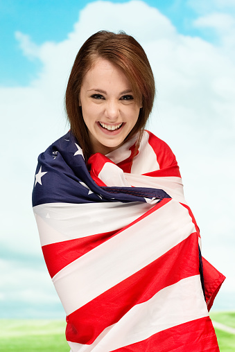 Cheerful woman wrapped in American flaghttp://www.twodozendesign.info/i/1.png