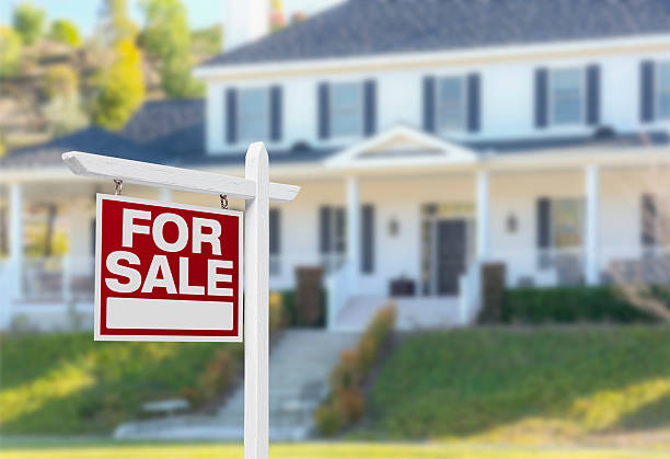 Home For Sale Sign in Front of New House Home For Sale Real Estate Sign in Front of Beautiful New House. houses for sale stock pictures, royalty-free photos & images