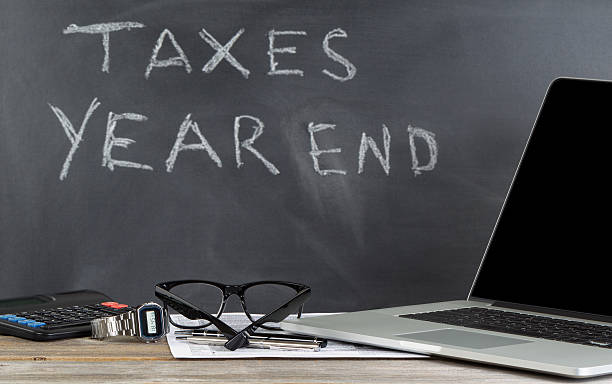 istock Desktop and chalkboard for working on income taxes 502214088