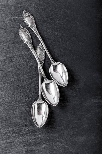 Silver spoon Silver spoon vintage, early 1930s with elaborate floral design baby spoon stock pictures, royalty-free photos & images