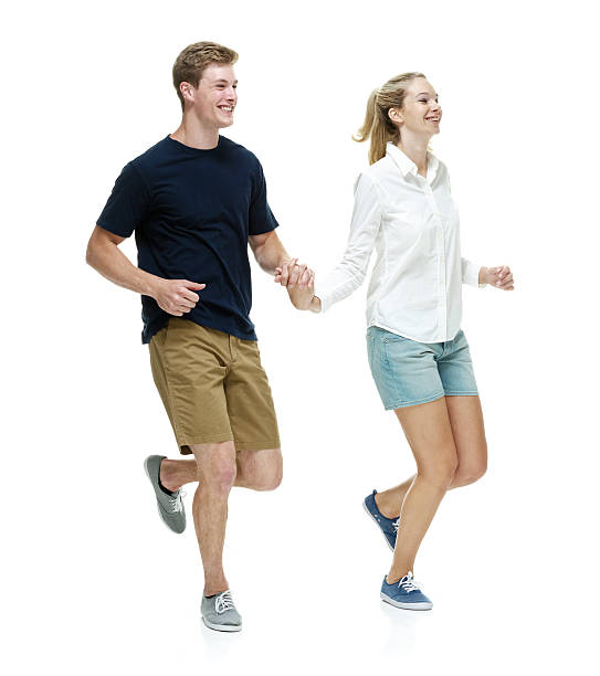 istock Smiling couple holding hands and running 502214820