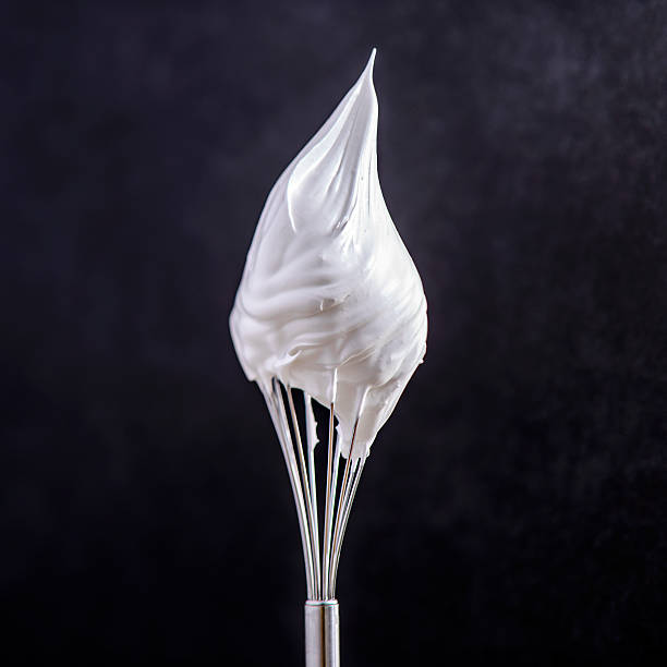 whip cream on top of whisk stock photo