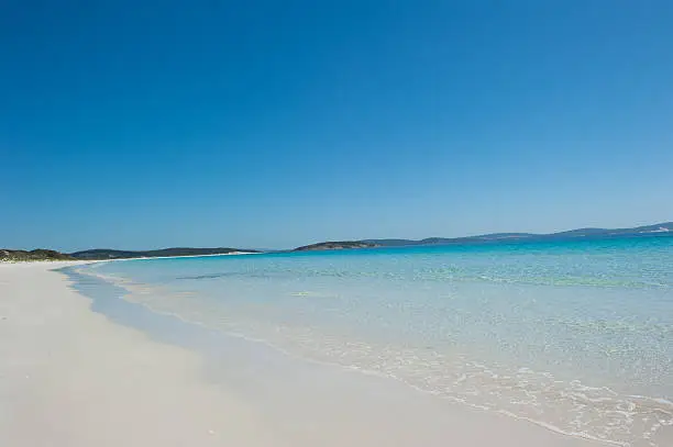 Scenic Tropical looking White Sandy Goodes Beach in Albany, Western Australia, overlooking deep sea water bay of King George Sound, blue sky, copy space.