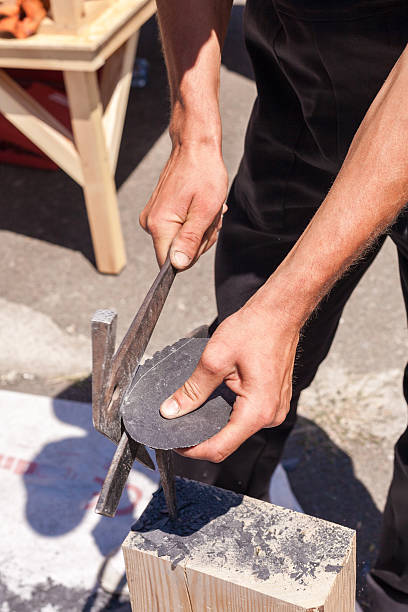 istock Worker produces roofing slate using a slate hammer 502216350