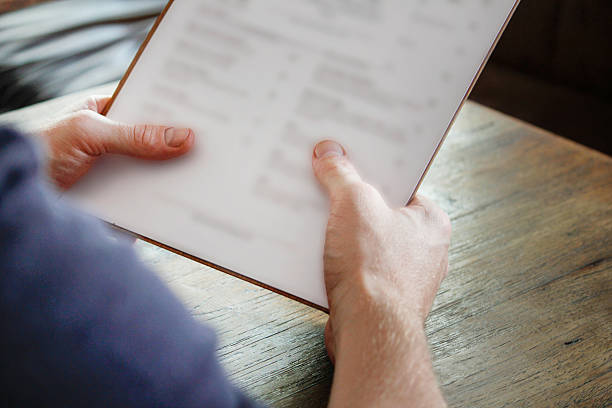 istock Young men reading food and drinks menu 502218010