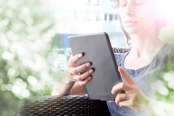 istock Young woman reading on her tablet 502218350