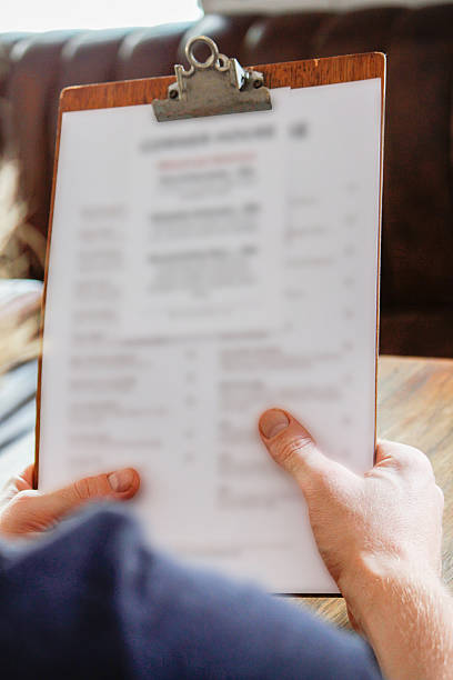istock Man holding food and drinks menu at restaurant 502218800
