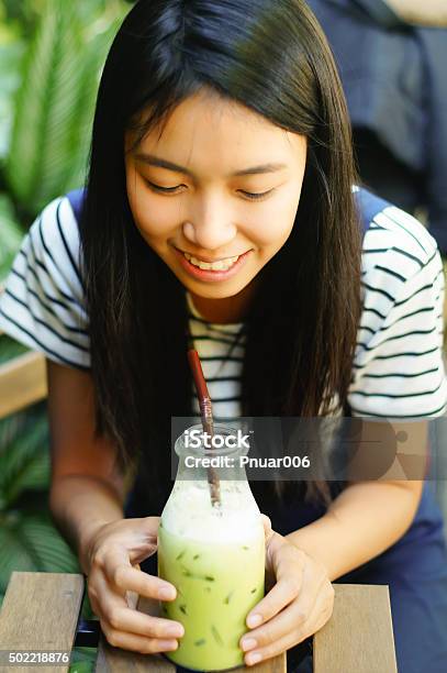 Girl Drinking Iced Green Tea Stock Photo - Download Image Now - 2015, Cafe, Cold Temperature
