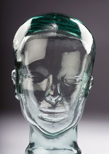 Glass head of young man.