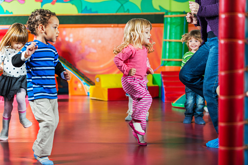 Cute kids dancing in the playroom.   