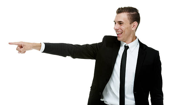 istock Smiling businessman pointing away 502219586