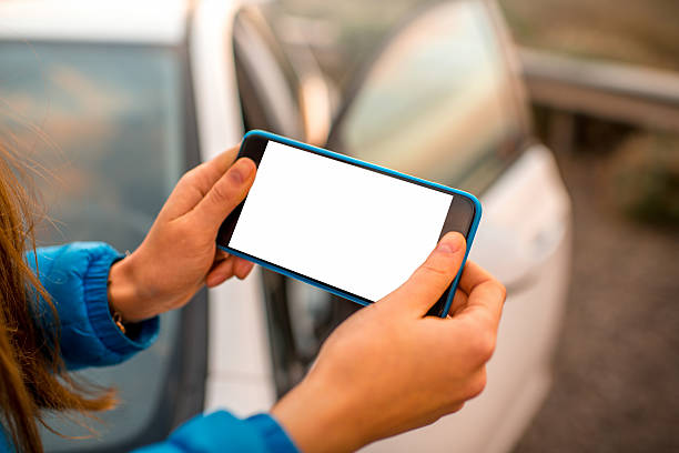 istock Female hands using smartphone on the road 502219674