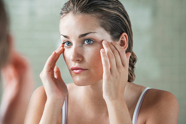 istock Woman Examining Herself In Front Of Mirror 502220305