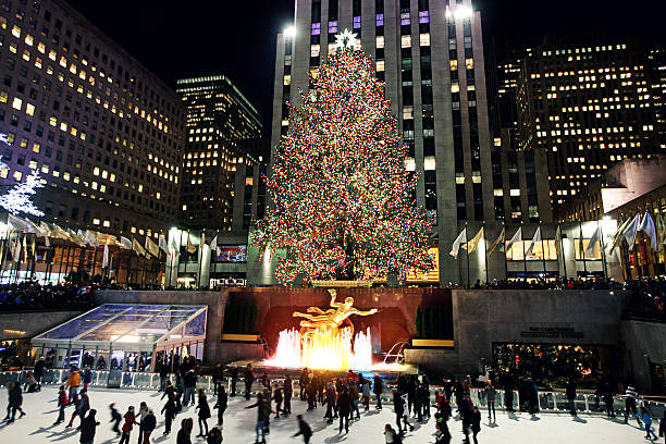 Christmas Tree at Rockefeller Center in New York City New York City, NY, USA – December 28, 2014: Rockefeller Center Christmas Tree lit up for the holidays. People skating in the Rockefeller Center Ice Rink. new years eve new york stock pictures, royalty-free photos & images