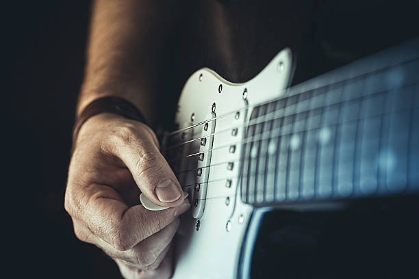 istock Young man playing electric guitar 502220420