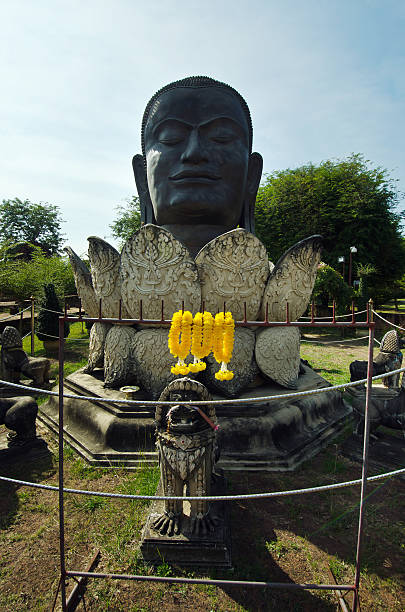 istock Black Buddha head and lotus statue 502221058