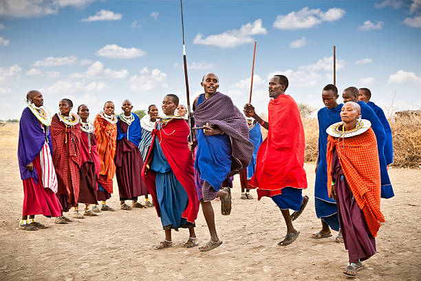 Masai warriors dancing traditional jumps as cultural ceremony, Tanzania. Tanzania, Africa - February 9, 2014: Masai warriors dancing traditional jumps as cultural ceremony, review of daily life of local people on February 9, 2014. Tanzania. masai stock pictures, royalty-free photos & images