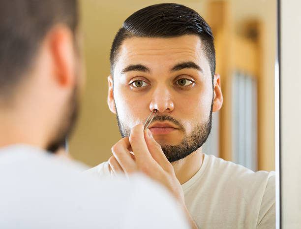 istock Guy removing nose hair 502221924