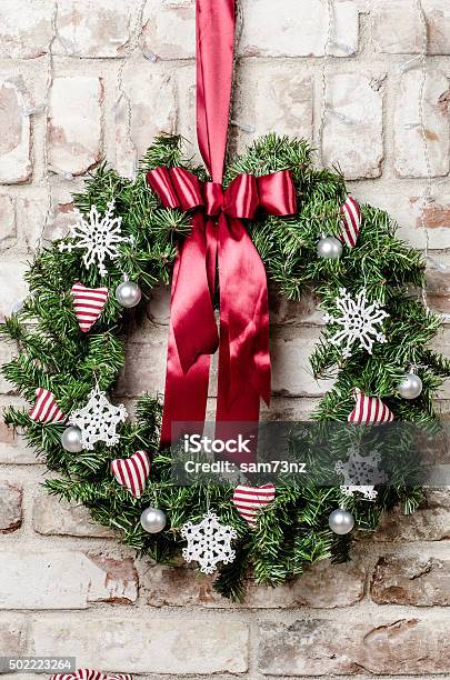 Christmas Wreath Stock Photo - Download Image Now - Brick Wall, Wreath, White Color