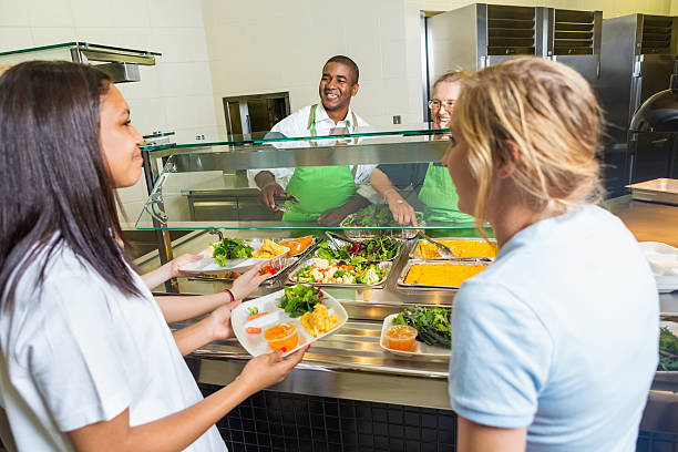 istock High school cafeteria workers serving healthy lunch options to students 502224591