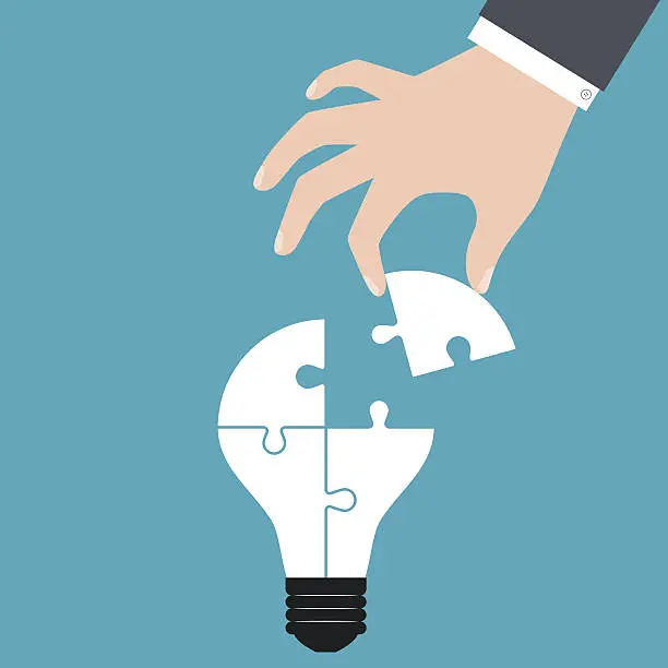 Vector illustration of Hand holding a puzzle piece to build lamp bulb