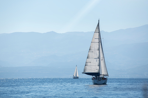 Ship yachts with white sails in the Sea. Sailing. Luxury Lifestyle.