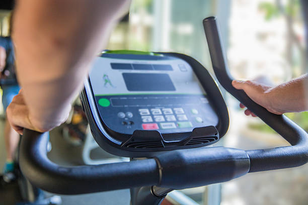 istock Close up males hand holding bicycle - exercising at  gym 502248832