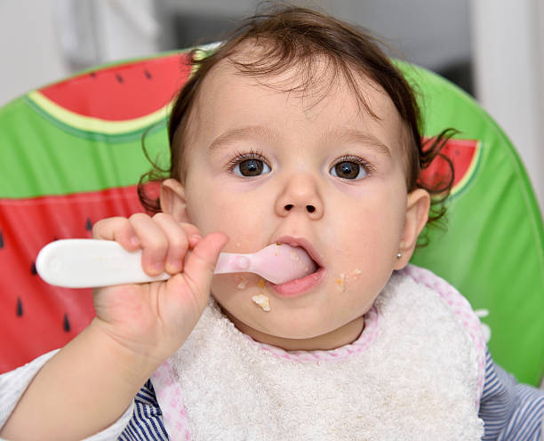 istock Baby girl eating 502249954