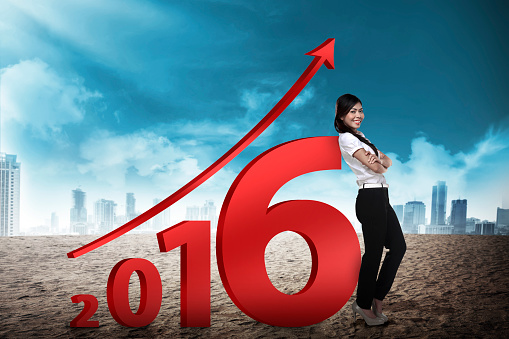 Asian business person lean next to 2016 number. New year resolution concept