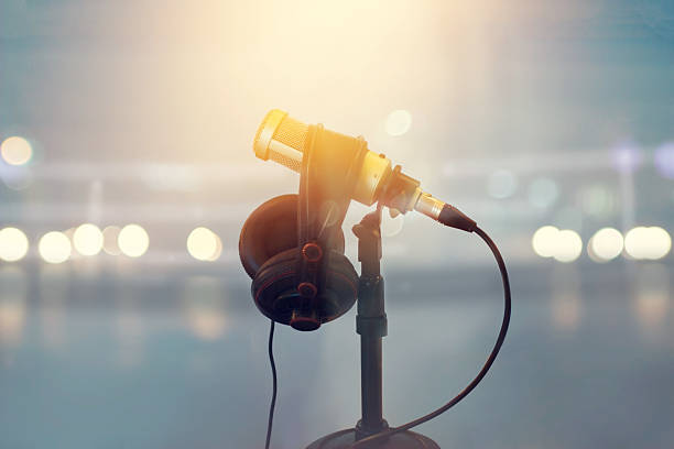 Close up microphone and headphone for announcer in boxing stadium Close up microphone and headphone for announcer in boxing stadium, vintage color tone commentator photos stock pictures, royalty-free photos & images