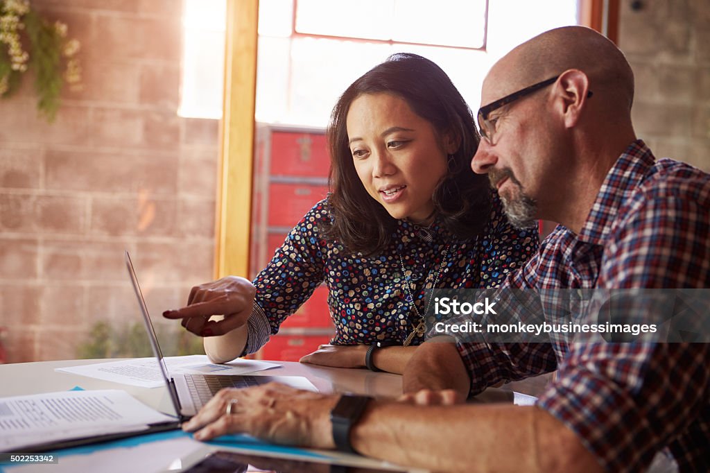 Two Designers With Laptop Meeting In Modern Office Meeting Stock Photo