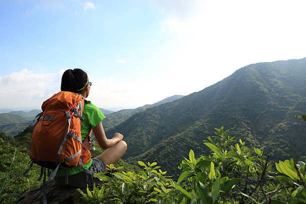 istock woman backpacker enjoy the view at mountain peak cliff 502254208