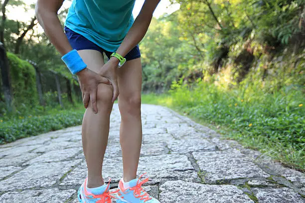 Photo of woman runner hold her sports injured knee