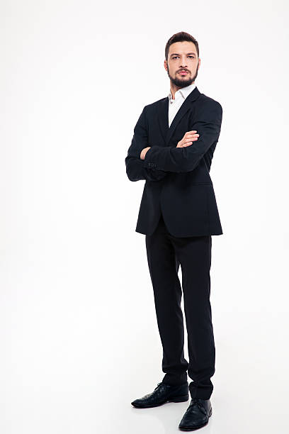 istock Serious businessman standing with arms folded 502254742
