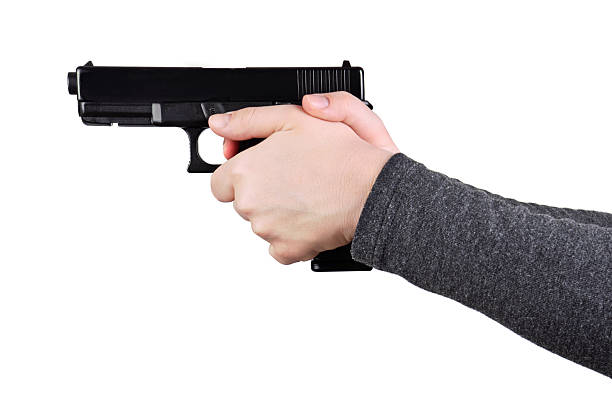 Close up of a gun in a hands Close up of female hands aiming gun on a white background target shooting photos stock pictures, royalty-free photos & images