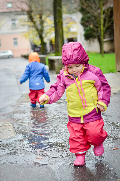 istock Twin babies in rain clothes 502255094