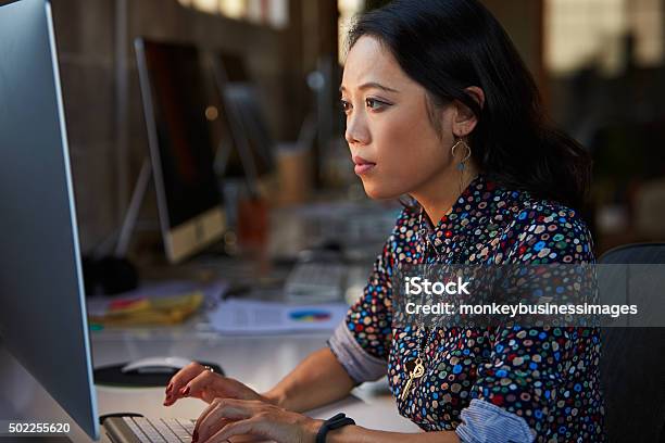 Female Designer Working At Desk In Modern Office Stock Photo - Download Image Now - Asia, Design Professional, Females