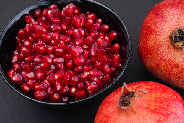 istock Pomegranate seeds in a black bowl 502256118