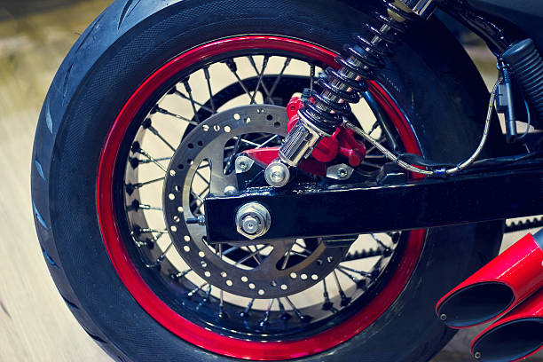 istock red motorcycle back wheel on wooden background 502256580