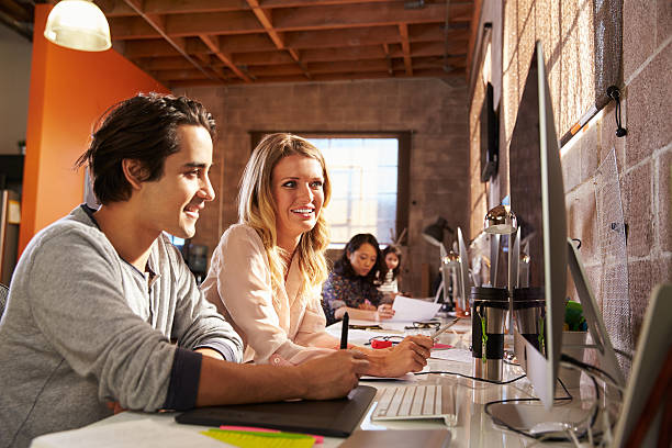 istock Designers Working Together At Desks In Modern Office 502259044