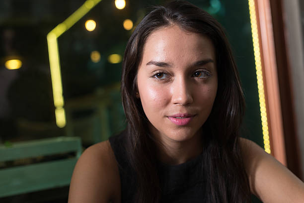 istock Beautiful woman sitting outdoors at night 502259138