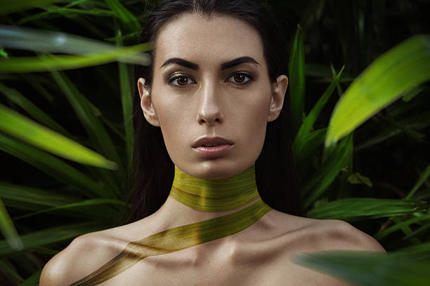 Fashion portrait with palm body paint on her neck.