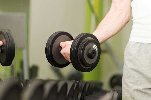 istock Unrecognizable person taking dumbbells in a gym 502260560
