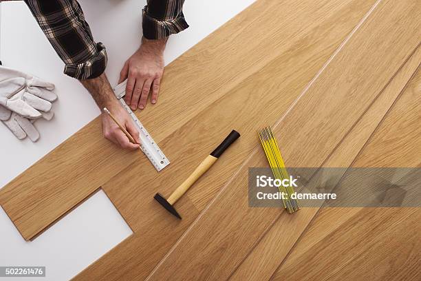 Carpenter Installing A Wooden Flooring Stock Photo - Download Image Now - Flooring, Carpenter, Parquet Floor