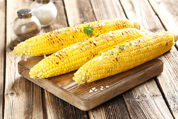 istock Fresh tasty grilled corn with butter on brown table 502261746
