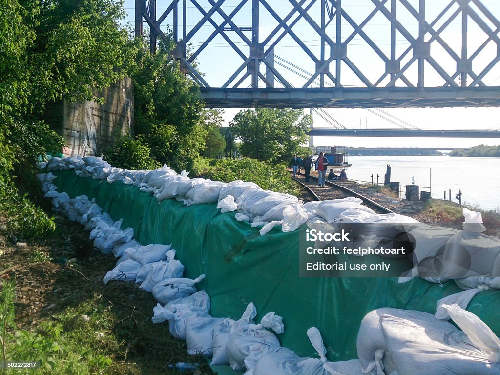 protection of the coast from the river Sava in Belgrade Obrenovac, Serbia - May 18, 2014: protection of the coast from the river Sava in Belgrade with sacks full of sand and nylon around them with volunteers assist in building wall, Gazela bridge, flood and disaster in Serbia 2014 Accidents and Disasters Stock Photo